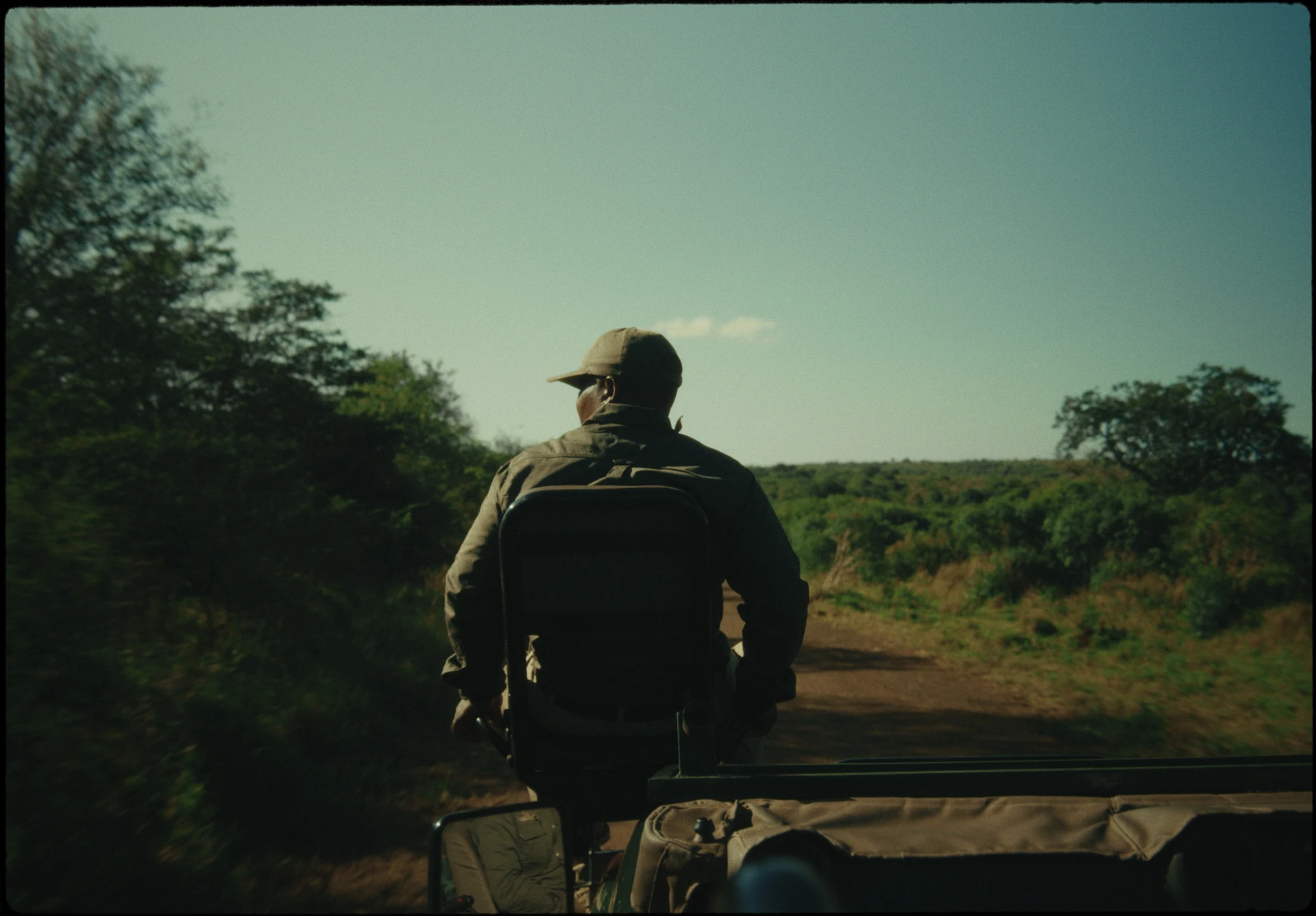 Un guide assis à l’avant d’un véhicule de safari.
